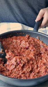 When the beef is fully cooked, add tomato paste, tomato sauce, and kidney beans, and let it simmer. 